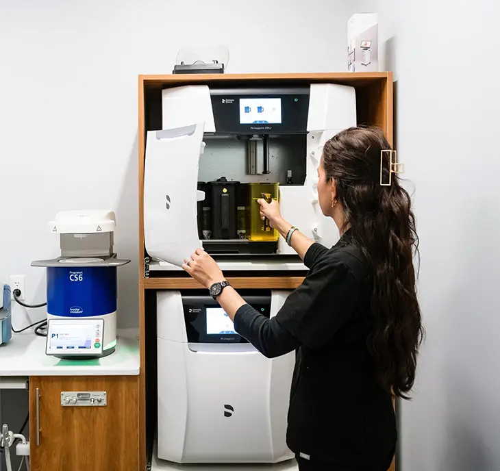 Dental staff operating autoclave sterilization equipment at Dr. Sara Syed Dentistry